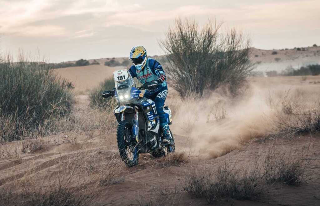 Motorcyclist on a rally Yamaha with start number 191 in sandy scrubland