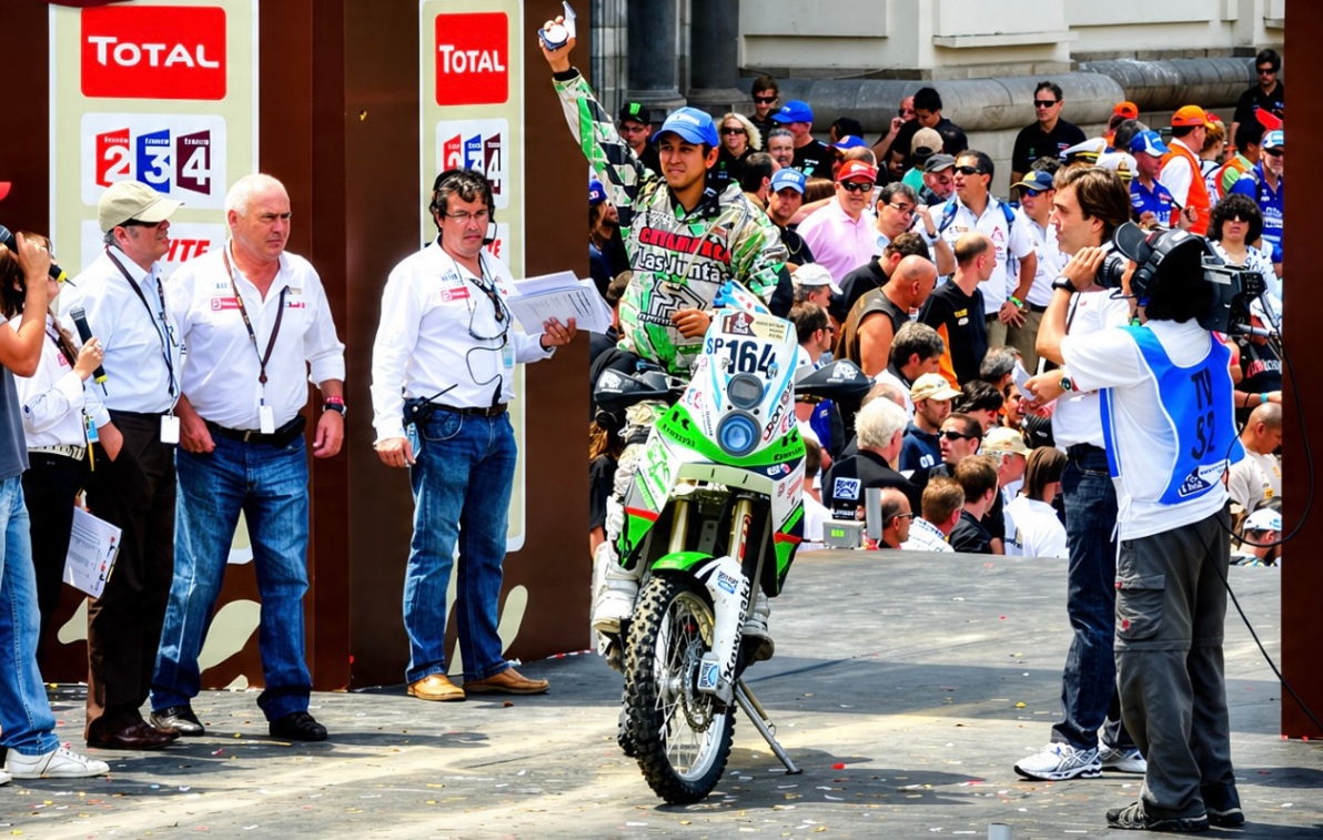 Motorcyclist with number 164 raising an arm at a ceremony on a town square, surrounded by officials and spectators