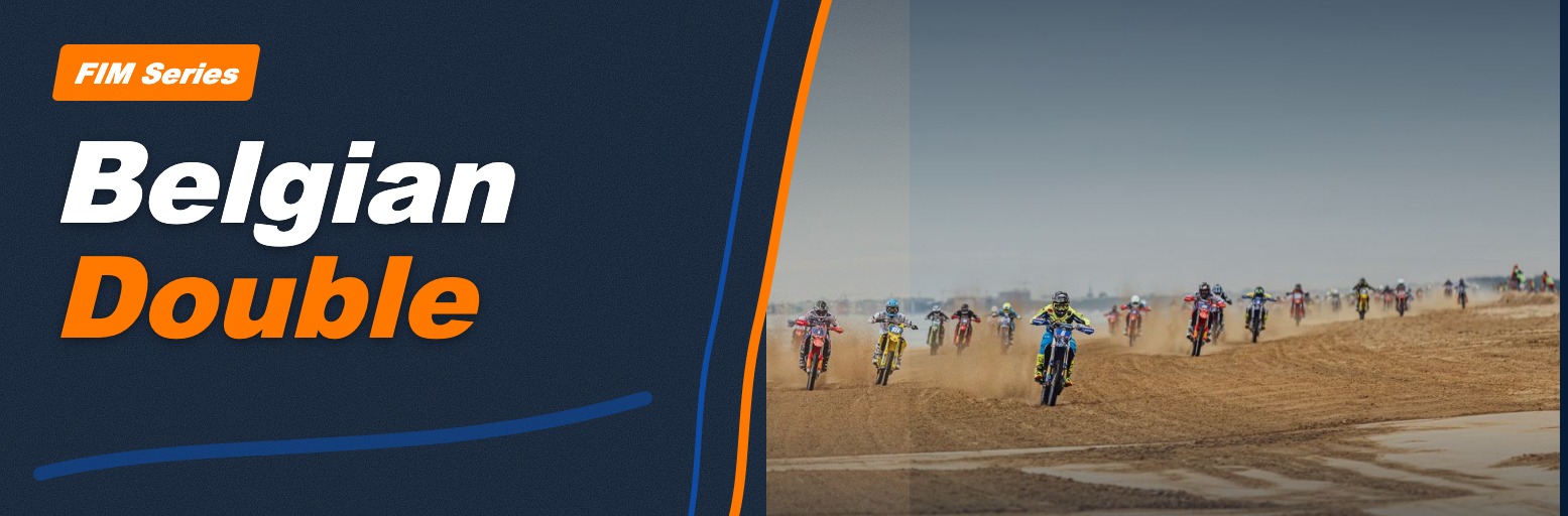 Riders in a sand race cross a beach in a wide pack