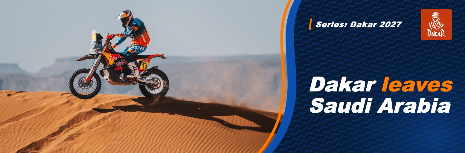 KTM rally rider with number 73 on the crest of a sand dune